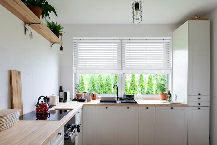 Bright kitchen with white window blinds